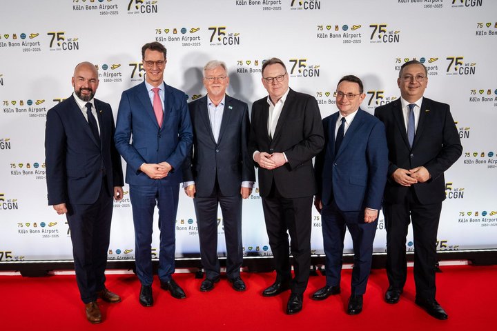 Vertreter des Flughafens und aus der Politik auf einer Bühne.